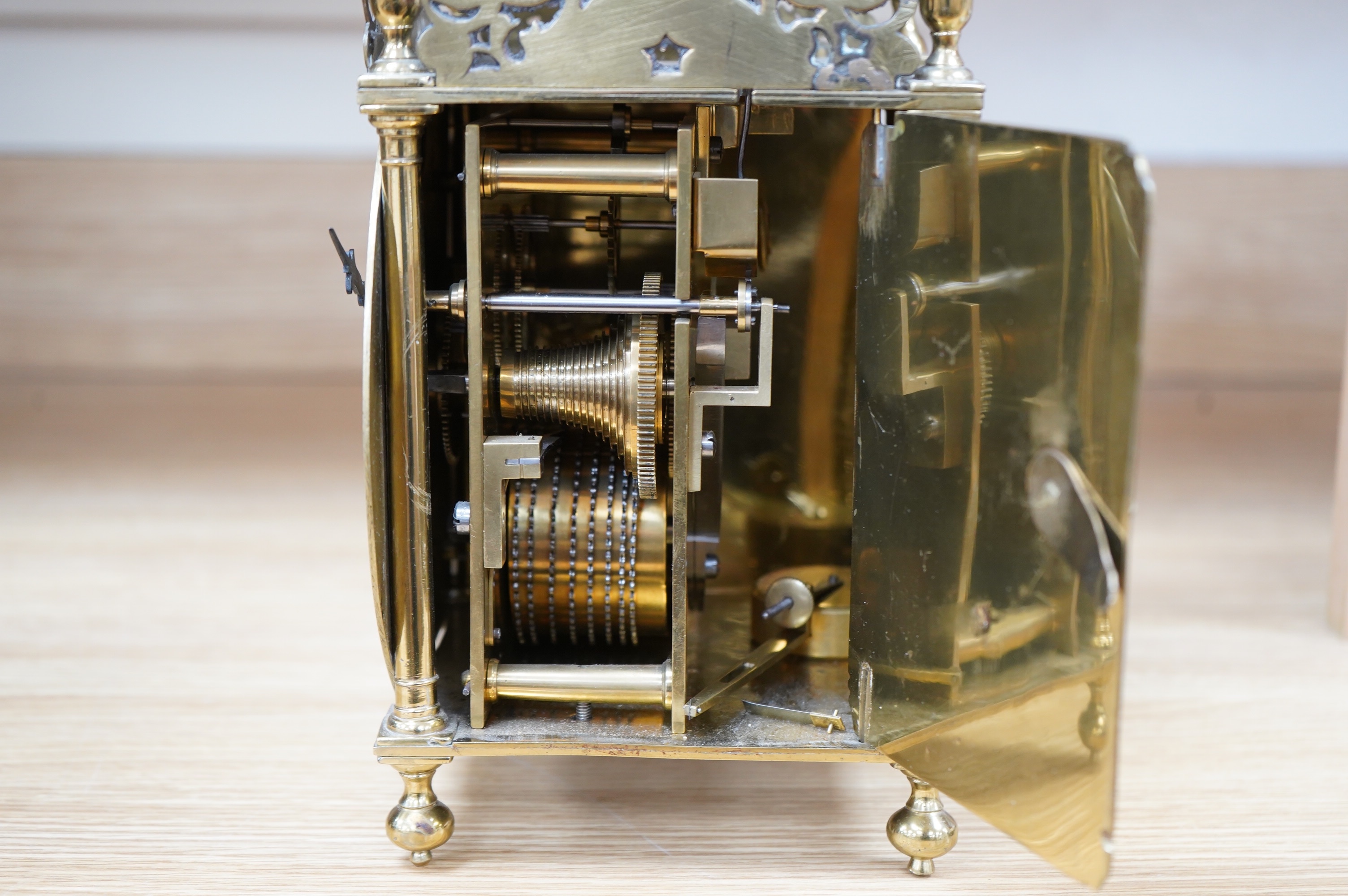 Manner of Richard Rayment of Bury. A Victorian 17th century style lantern clock, in traditional brass case with silvered Roman dial and eight day single fusee movement striking on a bell, 17cm wide, 14.5cm deep, 38cm hig
